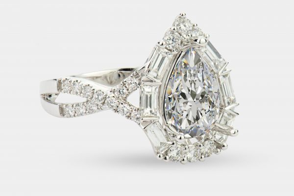18kt White Gold Pear Halo Engagement Ring With Infinity Shank and Baguettes